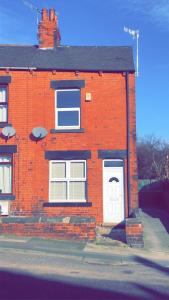 a red brick house with a white door at House in Hemingfield, Ideal for Contractors and Long Stays in Wombwell