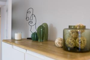a shelf with cacti and a candle on it at Nad Potokiem Apartment Poznań by Renters in Poznań