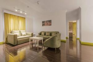 a living room with a couch and a table at Super 8 Hotel Al Riyadh by Wyndham in Riyadh