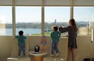 a woman and two children looking out of a window at Hyatt Regency Long Beach in Long Beach