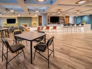 a conference room with tables and chairs and a bar at Hyatt Regency Long Beach in Long Beach