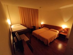 Postel nebo postele na pokoji v ubytování Hotel Berga Park