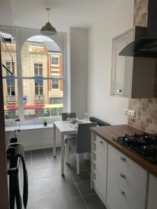 a kitchen with a table and a view of a building at City Centre 1 Bed Sleeps 4 H5 in Hull