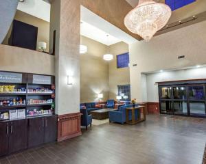 a waiting room of a pharmacy with blue chairs and a chandelier at Comfort Suites Idabel in Idabel