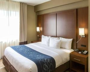 a hotel room with a large bed and a window at Comfort Suites Idabel in Idabel +29 photos