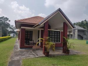 a small house with a red brick at Dubare Inn Coorg in Siddapur