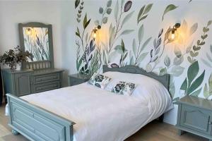 a bedroom with a bed with two night stands and two tables at Grande Villa de 8 chambres avec Balnéothérapie- Vill'Acacia in Bray-Dunes