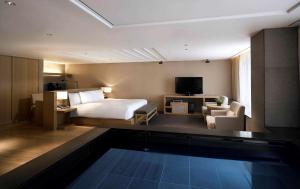 a hotel room with a bed and a swimming pool at Banyan Tree Club & Spa Seoul in Seoul