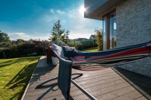 a hammock on the deck of a house at Cozy terraced house with infra sauna and parking in Jesenice