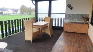 a dining room with a table and chairs on a balcony at Work & stay apartment with balcony near Ingolstadt in Großmehring