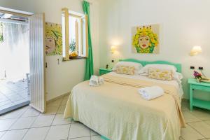 a bedroom with two beds and a window at Hotel Ossidiana Stromboli Center in Stromboli