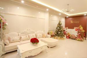 a living room with a christmas tree and a couch at DKD TRIO Hotel in Hue