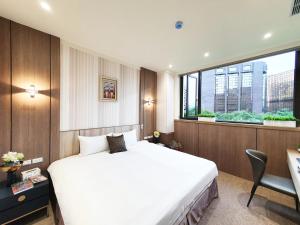 Rúm í herbergi á Grace Hotel Dunbei