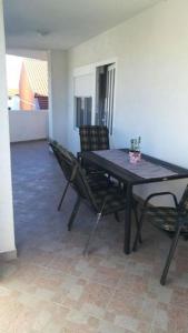 a dining room with a table and chairs in a room at Apartment in Tribunj with terrace, air conditioning, WiFi 5038-4 in Tribunj +15 photos