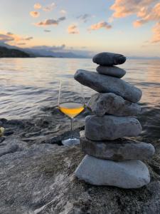 a stack of rocks and a glass of orange wine at Il Tramonto in Shirokë