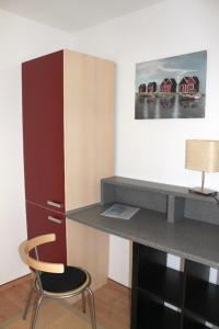 a kitchen with a desk and a chair in a room at Ostseeoase in Ratekau