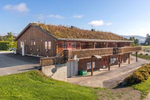 a building with a grass roof on top of it at Topcamp Mjøsa - Brumunddal in Brumunddalen