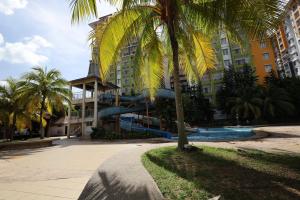 a resort with a water slide in front of a building at TOP 1 family trip relax resort in melaka pecuma water park tiket in Melaka