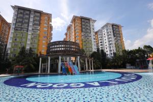 a playground in a pool with buildings in the background at TOP 1 family trip relax resort in melaka pecuma water park tiket in Malacca