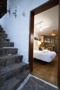 サン・セバスティアン・デ・ラ・ゴメラにあるLa Piedra Blancaのベッドルーム1室(ベッド1台付)、階段が備わります。