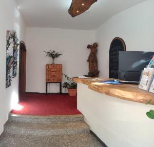 a hallway with a counter and a red carpet at Landhaus Schönblick in Bad Kohlgrub