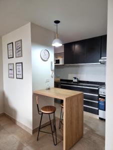 a kitchen with a wooden table and a chair at Monoambiente San Martin in San Salvador de Jujuy