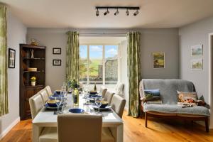 a dining room with a table and chairs and a window at Finest Retreats - Bodlawen Holiday House - Edge of Snowdonia in Cerrig-y-Druidion