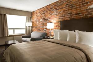 A bed or beds in a room at Super 8 by Wyndham Timmins ON