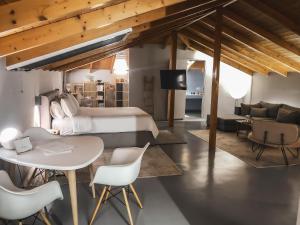 a bedroom with a bed and a table and chairs at API Projects Nafplio - Superior Loft in Nafplio