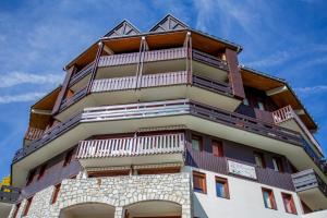 a tall building with balconies on top of it at T-du Morel- A44- Studio grande terrasse-4 pers in Doucy