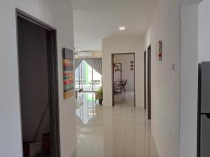 a hallway of a house with white floors and ceilings at KH Water Park Manhattan Condo Ipoh Homestay in Kampong Pinji