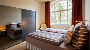 a bedroom with a bed and a large window at Parkresidenz Lychen Ferienwohnung 2 in Lychen