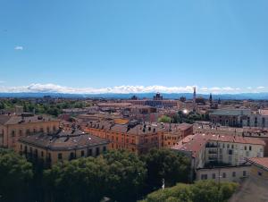 an aerial view of a city with mountains in the background at Dante's House - Affittacamere in Modena