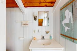a bathroom with a sink and a mirror at Edgewater Acres --- 39167 Garfield Avenue in Selbyville +20 photos