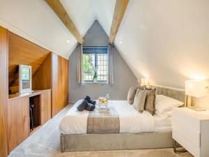 a bedroom with a large bed and a window at luxury 2 bed cosy cottage with hot tub and childrens play area hambrook Bristol in Bristol