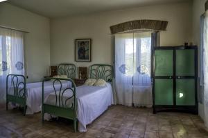a bedroom with two beds and a window at Agriturismo Piano del Monaco in Marcellinara