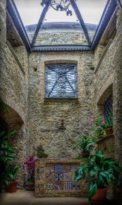 a stone building with a window and plants at Agriturismo Piano del Monaco in Marcellinara
