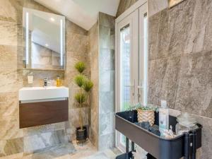 a bathroom with a sink and a mirror at 2 bedroom cosy cottage with hot tub in hambrook close to Bristol City Centre in Bristol +34 photos