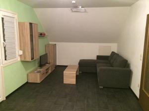a living room with a couch and a tv at Ferienwohnung Ludwig in Karlstadt