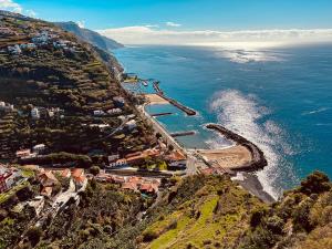 an aerial view of a town on a hill next to the ocean at Madeira Inn Vilamar 2 in Calheta