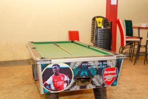 a pool table in a room with stickers on it at TRIPLINQ HOTEL & RESORT Meru in Nkubu