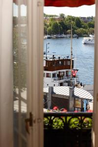 a view of a boat in the water from a window at Hotel Diplomat Stockholm in Stockholm