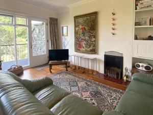 a living room with a couch and a fireplace at Cottage 430 - Roundstone in Roundstone