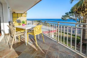 a balcony with a table and chairs and the ocean at Deauville Miami platja in Miami Platja