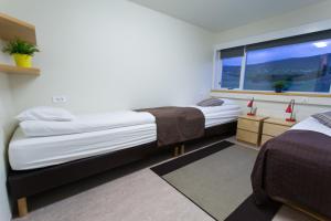 מיטה או מיטות בחדר ב-Hotel Mikligardur