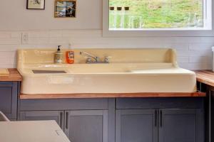 a white sink in a kitchen with a window at The Nordic Nest in Margaretville