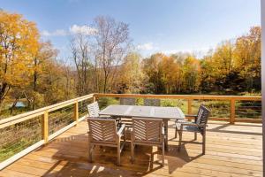 a wooden deck with a table and chairs on it at The Nordic Nest in Margaretville
