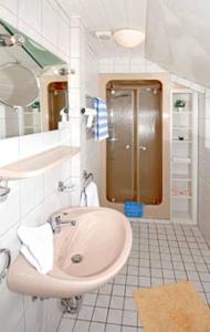 a bathroom with a sink and a shower at Hotel-Restaurant Zum Dorfkrug in Winterberg