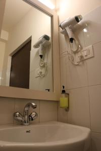 a bathroom with a sink and a mirror at The Nettle and Fern Farmstay in Pelling