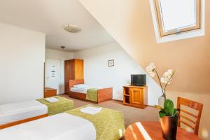 um quarto de hotel com duas camas e uma mesa em Baross City Hotel - Budapest em Budapeste
